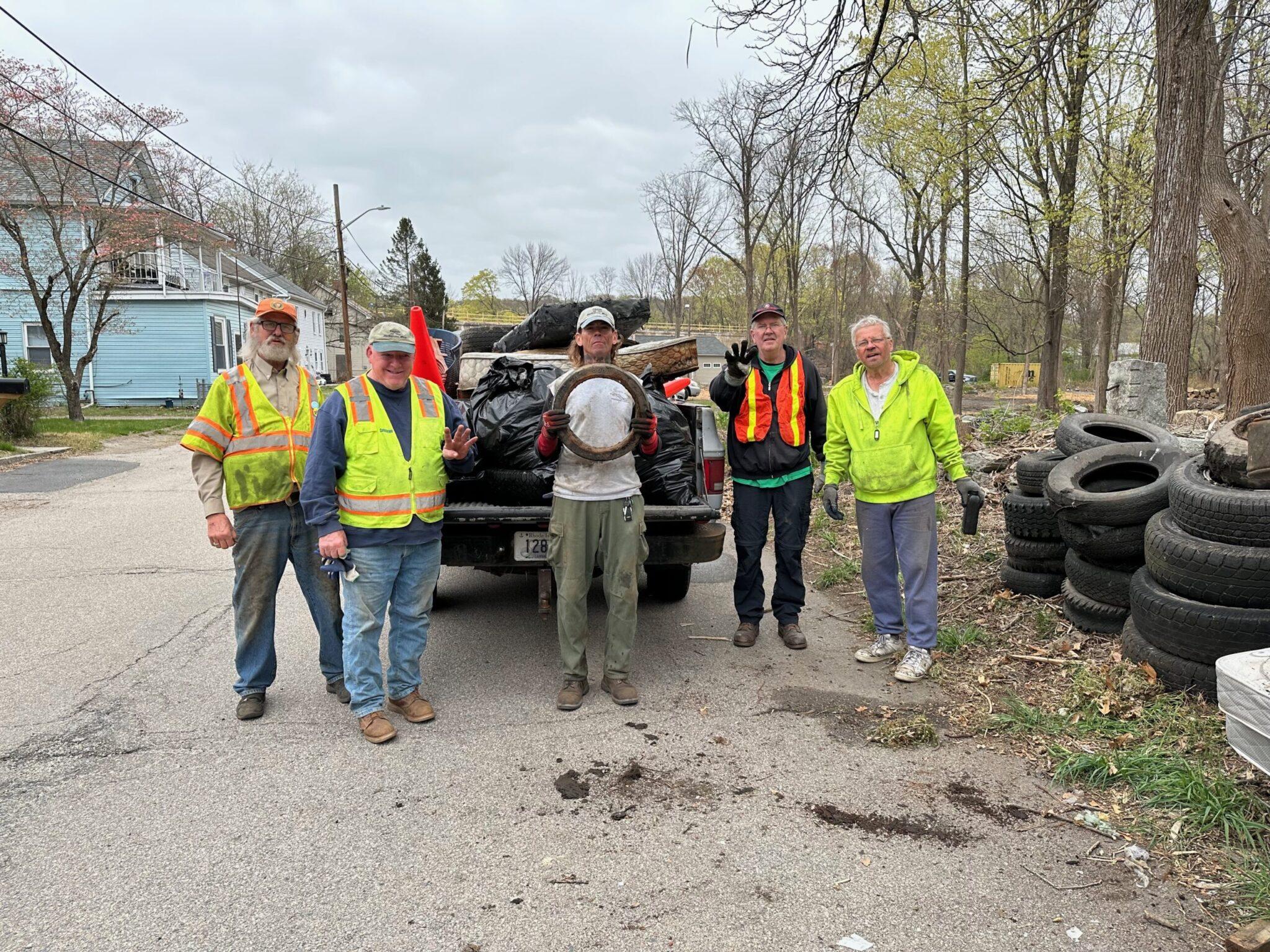 Volunteers clean up tires and debris at Blackstone River Watershed, organized by local council.
