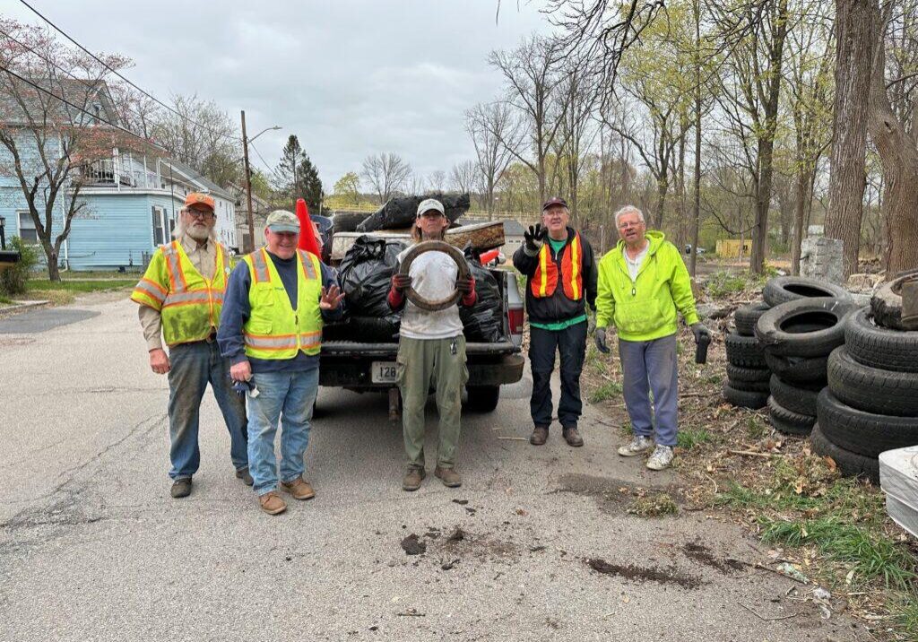 Volunteers clean up tires and debris at Blackstone River Watershed, organized by local council.